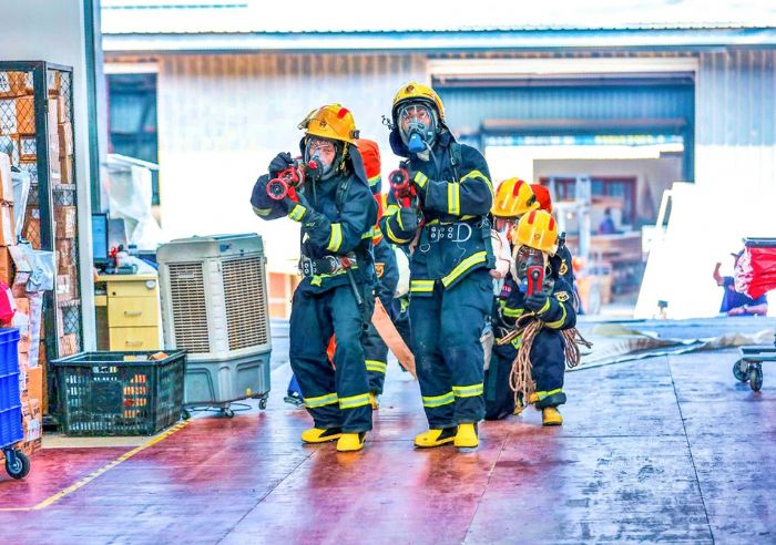 消防救援人员进入仓库灭火。
