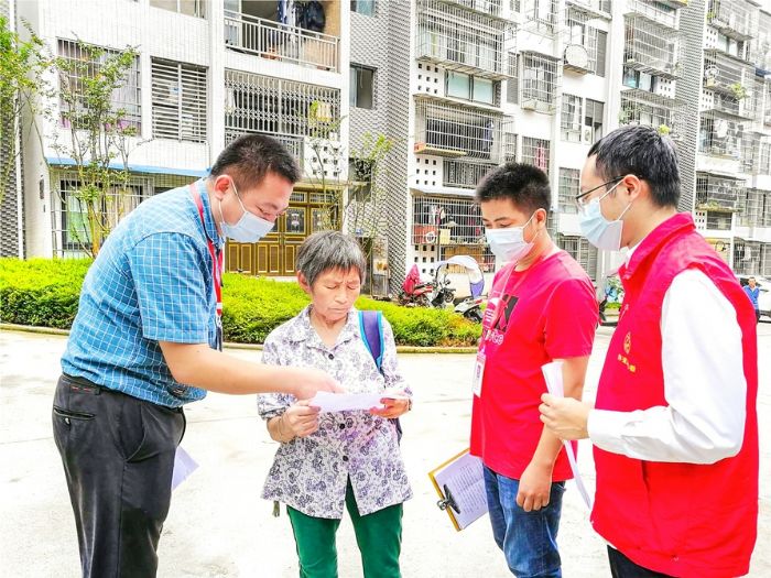 李朝波和志愿者向社区居民宣传疫情防控知识。
